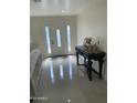 Inviting entryway with gleaming tile floors, decorative table with roses, and decorative glass front door at 6107 N 126Th Ave, Litchfield Park, AZ 85340
