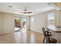 Open living room with tile flooring, sliding glass doors, and views of the outdoor space at 8007 S 69Th Dr, Laveen, AZ 85339