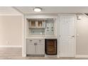 Cozy wet bar with gray cabinetry, wine fridge, and tiled backsplash at 835 N Granite Reef Rd # 29, Scottsdale, AZ 85257