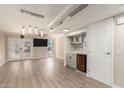 Open-concept living room with new floors, ceiling fan, and a small bar at 835 N Granite Reef Rd # 29, Scottsdale, AZ 85257