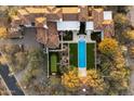 Aerial view of a luxury home showcasing the pool, putting green, and meticulously landscaped backyard at 10244 E Hualapai Dr, Scottsdale, AZ 85255