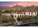 Stunning estate with mountain views features a tile roof, manicured landscaping, and a grand entrance at 10244 E Hualapai Dr, Scottsdale, AZ 85255