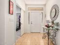 Inviting foyer with decorative mirror, tiled floor, and sidelight windows for a bright entrance at 11046 E Naranja Ave, Mesa, AZ 85209