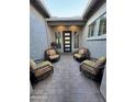 Cozy outdoor patio with four chairs and a view of the front door at 11612 W Candelilla Way, Peoria, AZ 85383