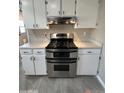 Stainless steel double oven range with custom white cabinets and countertops at 1172 E Delano Dr, Casa Grande, AZ 85122