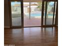 View through sliding glass doors to the pool and patio area, with brick pavers at 1172 E Delano Dr, Casa Grande, AZ 85122