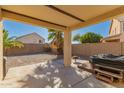 Back covered patio with a backyard view of desert landscaping, block wall, and clear sky at 14787 W Aster Dr, Surprise, AZ 85379