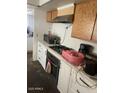 Kitchen with appliances including built-in cooktop and oven and white countertops at 155 W Hunter St, Mesa, AZ 85201