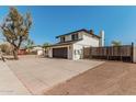 Backyard view of the home and driveway, featuring a private gated entrance at 15619 N 30Th Ave, Phoenix, AZ 85053