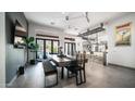 Open-concept dining room with tile floors, modern lighting, and sliding doors to the patio at 16060 S 4Th St, Phoenix, AZ 85048