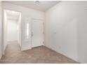 Inviting foyer with tile flooring and a bright entry door at 16549 W Rowel Rd, Surprise, AZ 85387