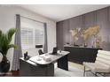 Modern office space with stylish desk, chair, and decorative world map, creating an inspiring work environment at 16549 W Rowel Rd, Surprise, AZ 85387