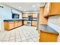 Bright kitchen with tile floors, stainless appliances, and plenty of cabinets at 17059 W Northampton Rd, Surprise, AZ 85374