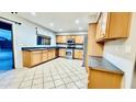 Well-lit kitchen with modern appliances, light wood cabinets, and tiled flooring at 17059 W Northampton Rd, Surprise, AZ 85374