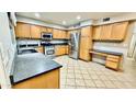 Spacious kitchen featuring light wood cabinetry, stainless steel appliances and granite countertops at 17059 W Northampton Rd, Surprise, AZ 85374