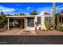 Charming single-story home featuring desert landscaping and a covered parking area, perfect for easy living at 17200 W Bell Rd # 119, Surprise, AZ 85374