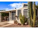 This property features charming desert landscaping and a well-maintained exterior with a covered carport at 17200 W Bell Rd # 119, Surprise, AZ 85374