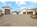 Spacious driveway leading to multiple garages, offering ample parking and storage space at 20216 E Sunset Ct, Queen Creek, AZ 85142