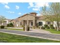 Beautiful stone facade and landscaped front yard enhance the property's charm and upscale feel at 20216 E Sunset Ct, Queen Creek, AZ 85142