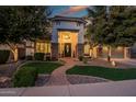 Charming home featuring a brick walkway leading to a grand entrance framed by lush greenery and manicured landscaping at 2484 E Lodgepole Dr, Gilbert, AZ 85298