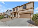 Exterior view of a stucco two-story house with a two-car garage and desert landscaping at 28793 N Spur Dr, San Tan Valley, AZ 85143