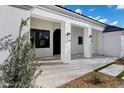 Inviting front entry with elegant columns and a covered porch, offering a glimpse of the home's refined architecture at 2964 E Palo Verde St, Gilbert, AZ 85296