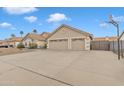 Home exterior featuring a driveway leading to a two-car garage, basketball hoop, and gravel yard at 3015 E Nora St, Mesa, AZ 85213