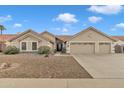 Home exterior featuring a gravel yard, well-maintained landscaping, and a driveway leading to a two-car garage at 3015 E Nora St, Mesa, AZ 85213