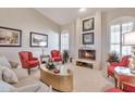 Inviting living room featuring a cozy fireplace, neutral walls and bright, natural light at 3032 N 160Th Ave, Goodyear, AZ 85395