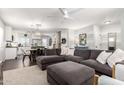 Open-concept living room with a large grey sectional sofa, white walls, and a ceiling fan at 337 S Leandro --, Mesa, AZ 85208