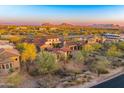 Stunning aerial view of luxury homes with mountain views in a desert setting at 37505 N 104Th Pl, Scottsdale, AZ 85262