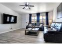 Comfortable living room with TV, ceiling fan, and neutral decor at 4026 N 81St St, Scottsdale, AZ 85251