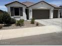 Charming single-story home with a two car garage, desert landscaping, and a neutral color palette at 40440 W Haley Dr, Maricopa, AZ 85138
