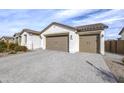 A single-story home features a two-car garage and a beautifully paved driveway at 40440 W Haley Dr, Maricopa, AZ 85138