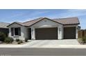 Charming single-story home with a two car garage, desert landscaping, and a neutral color palette at 40440 W Haley Dr, Maricopa, AZ 85138