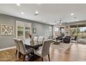 Open concept living area featuring hardwood floors, plantation shutters, and modern furnishings at 41208 N Prestancia Dr, Anthem, AZ 85086