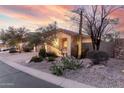 Desert landscaping surrounds a single-story home with a charming, welcoming entrance at 4760 E Amber Sun Dr, Cave Creek, AZ 85331