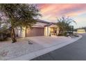 Single-story home featuring desert landscaping, a driveway, and a spacious two-car garage at 4760 E Amber Sun Dr, Cave Creek, AZ 85331