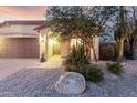 Inviting entrance with desert plants, a charming bench and a stylish, dark front door at 4760 E Amber Sun Dr, Cave Creek, AZ 85331