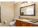Bathroom featuring granite countertops, wood cabinets, and a framed mirror at 5381 W Del Rio St, Chandler, AZ 85226