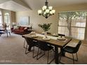 Cozy dining room featuring a wooden table, black chairs, and a modern chandelier at 5381 W Del Rio St, Chandler, AZ 85226