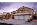 Charming two-story home featuring a three-car garage, desert landscaping, and well-lit exterior at 5381 W Del Rio St, Chandler, AZ 85226