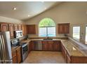 Well-appointed kitchen with granite countertops, stainless steel appliances and natural lighting at 5381 W Del Rio St, Chandler, AZ 85226