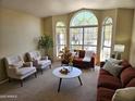 Inviting living room with large windows, stylish furniture, and neutral color palette at 5381 W Del Rio St, Chandler, AZ 85226