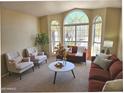 Bright living room features large windows, comfortable seating and cozy decor at 5381 W Del Rio St, Chandler, AZ 85226