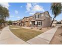 Beautifully landscaped community street with sidewalks, well-kept lawns, and charming homes with covered entries at 5824 E Hoover Ave, Mesa, AZ 85206