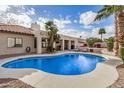 Backyard featuring a private pool, covered patio, and lush landscaping at 6118 E Star Valley St, Mesa, AZ 85215