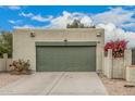 Image displays the front of a stucco house, featuring a garage, desert landscaping, and bougainvillea at 619 E Jensen St # 80, Mesa, AZ 85203