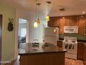 Inviting kitchen featuring pendant lighting, a large island, and modern appliances at 6437 W Devonshire Ave, Phoenix, AZ 85033