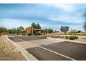 Well maintained community entry road featuring flowers and desert landscaping at 6634 S Pinnacle Ct, Chandler, AZ 85249